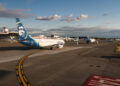 Planes lined up in traffic waiting for their turn to take off at Seattle-Tacoma Airport, Late in the day.