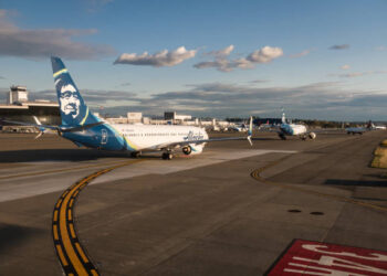 Planes lined up in traffic waiting for their turn to take off at Seattle-Tacoma Airport, Late in the day.