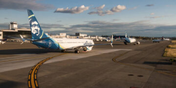 Planes lined up in traffic waiting for their turn to take off at Seattle-Tacoma Airport, Late in the day.