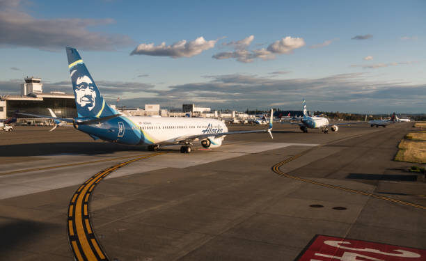 Planes lined up in traffic waiting for their turn to take off at Seattle-Tacoma Airport, Late in the day.