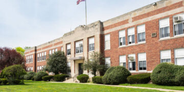Exterior view of a typical American school building seen on a spring day