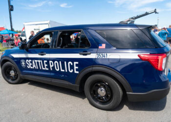 Seattle, WA, USA -July 3, 2024: Blue and white Seattle police car parked on street. Seattle state police