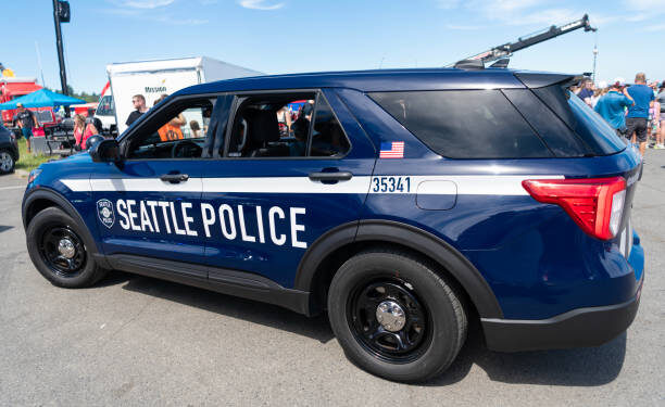 Seattle, WA, USA -July 3, 2024: Blue and white Seattle police car parked on street. Seattle state police